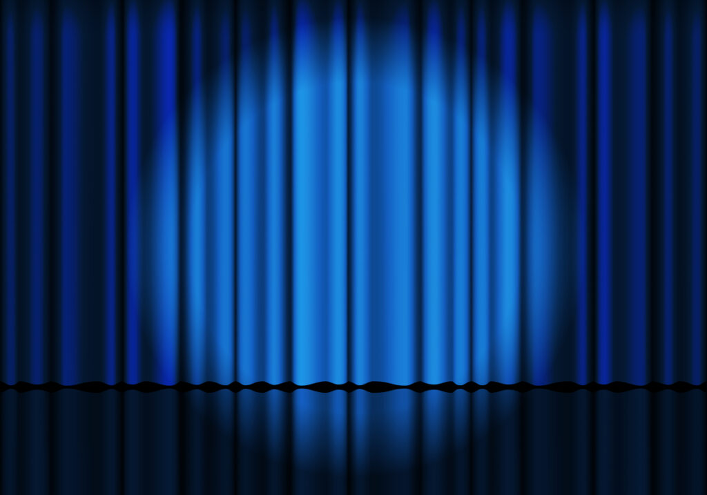 Blue curtain background. Spotlight on stage curtain. Theatrical drapes. Wavy velvet background.